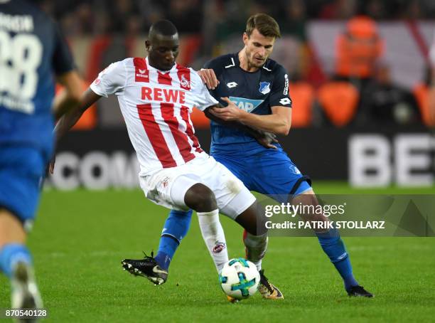 Cologne's French striker Sehrou Guirassy and Hoffenheim's midfielder Harvard Nordtveit vie for the ball during the German First division Bundesliga...