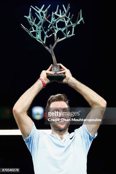 Jack Sock of the USA celebrates with the trophy after victory against Filip Krajinovic of Serbia in the Mens Final on day 7 of the Rolex Paris...