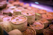Quality and finest short crust pork pies on display on a market stall or butchers in the UK