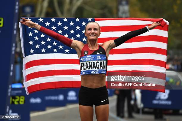 Shalane Flanagan of the US celebrates after she won the Women's Division during the 2017 TCS New York City Marathon in New York on November 5, 2017....