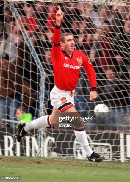 Manchester United's French star Eric Cantona celebrates a goal at Selhurst Park 03 February during United's Premiership match against Wimbledon, in...