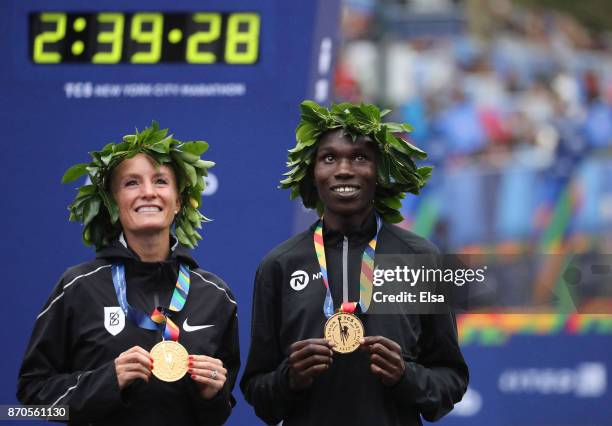 Shalane Flanagan of the United States and Geoffrey Kamworor of Kenya celebrate winning the Professional Divisions of the 2017 TCS New York City...