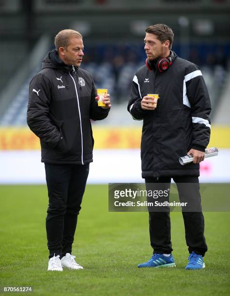 Head coach Markus Anfang of Holstein Kiel and Andreas Lambertz of Dynamo Dresden are seen prior to the Second Bundesliga match between Holstein Kiel...