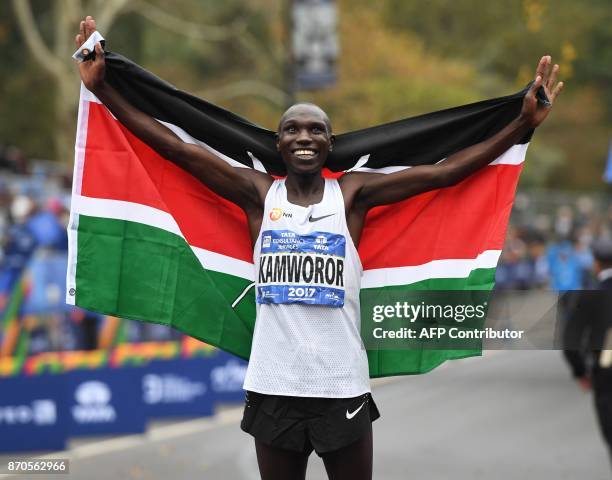 Geoffrey Kamworor of Kenya holds up his national flag as he celebrates winning the Men's Division during the 2017 TCS New York City Marathon in New...