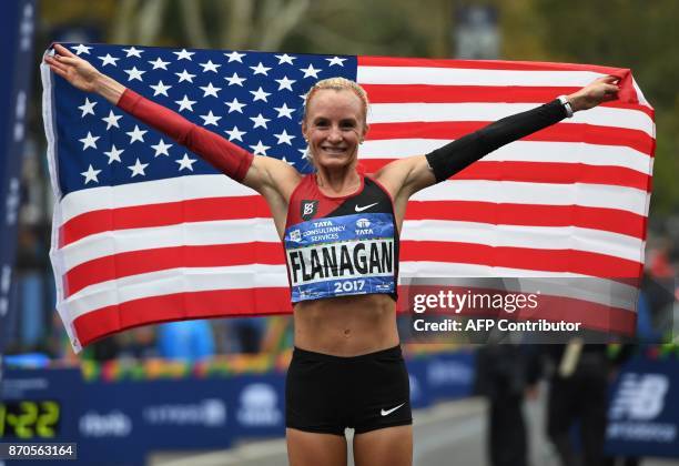 Shalane Flanagan of the US celebrates after she won the Women's Division during the 2017 TCS New York City Marathon in New York on November 5, 2017....