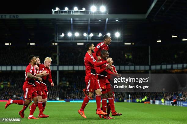 Christian Kabasele of Watford celebrates scoring his sides second goal with his Watford team mates during the Premier League match between Everton...