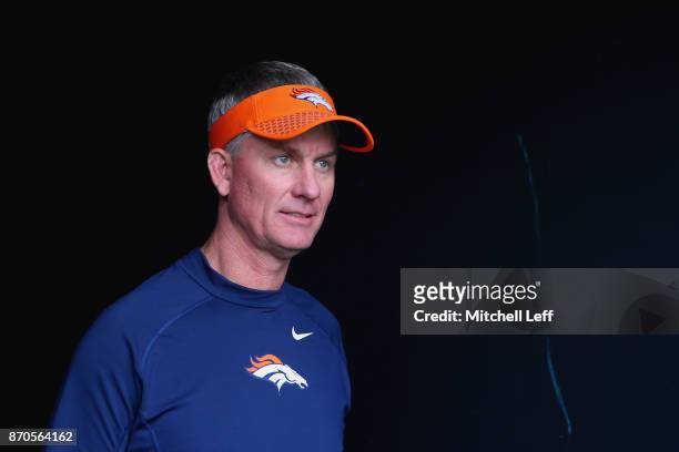 Mike McCoy, Offensive Coordinator for the Denver Broncos, walks out of the tunnel for warmups prior to the game against the Philadelphia Eagles at...