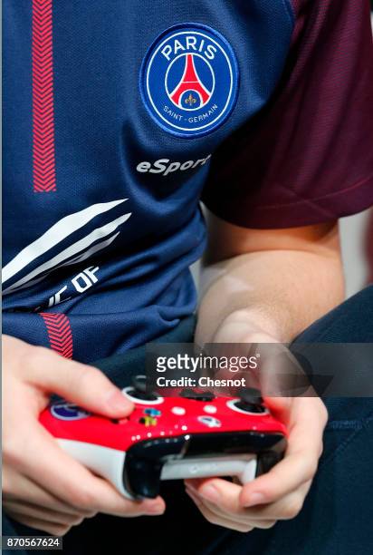 French player E-Sports, Lucas Cuillerier, gamertag 'DaXe' of the eSports team of Paris Saint-Germain uses a video game controller as he competes in...