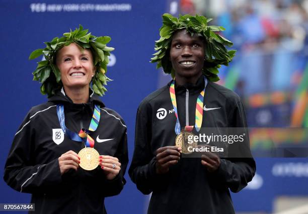 Shalane Flanagan of the United States and Geoffrey Kamworor of Kenya pose with their first place medals during the 2017 TCS New York City Marathon in...