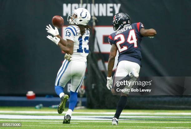 Hilton of the Indianapolis Colts catches a touchdown pass defended by Kurtis Drummond of the Houston Texans in the first quarter at NRG Stadium on...