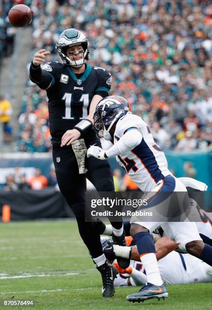 Quarterback Carson Wentz of the Philadelphia Eagles throws a pass against defensive back Will Parks of the Denver Broncos during the first quarter at...