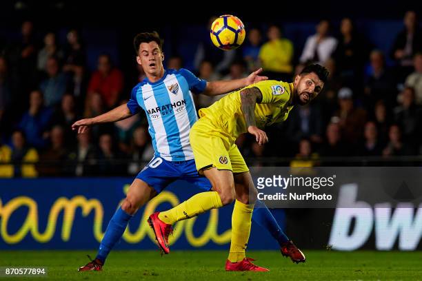 Soriano of Villarreal CF competes for the ball with Juanpi of Malaga CF during the La Liga match between Villarreal CF and Malaga CF at Estadio de la...
