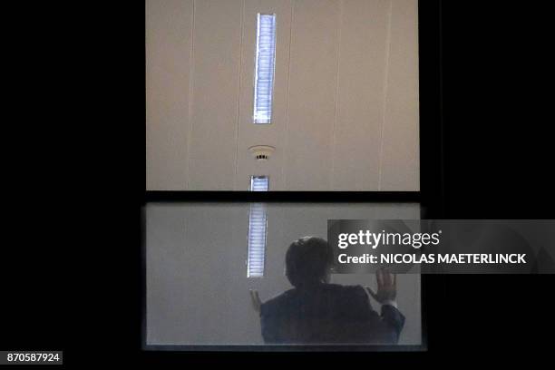 Man believed to be Carles Puigdemont gestures inside the public prosecutor's office in Brussels, on November 5, 2017. Catalonia's sacked separatist...
