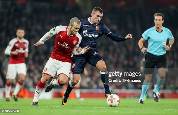 Jack Wilshere of Arsenal and Nenad Krsticic of Red Star Belgrade battle for the ball during UEFA Europa League Group H match between Arsenal and Red...
