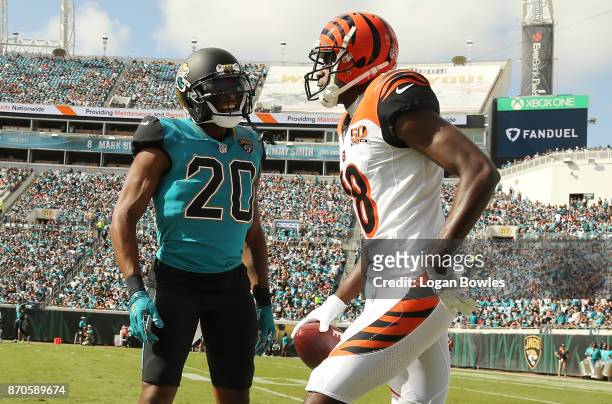 Green of the Cincinnati Bengals and Jalen Ramsey of the Jacksonville Jaguars discuss a play in the first half of their game at EverBank Field on...