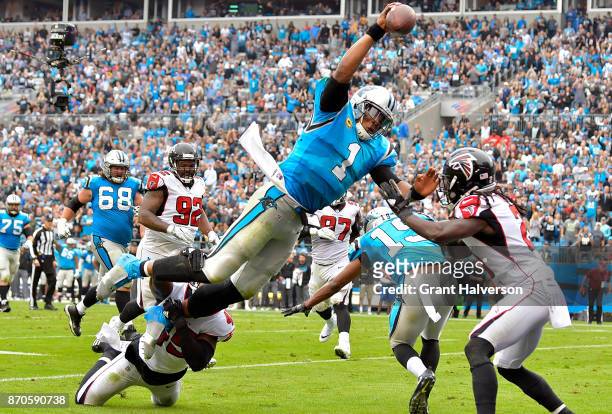 Cam Newton of the Carolina Panthers dives into the end zone for a touchdown during the second quarter of their game against the Atlanta Falcons at...