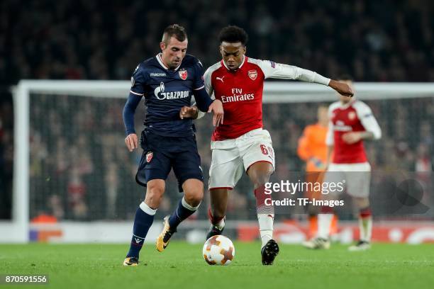 Nenad Krsticic of Red Star Belgrade and Joseph Willock of Arsenal battle for the ball during UEFA Europa League Group H match between Arsenal and Red...