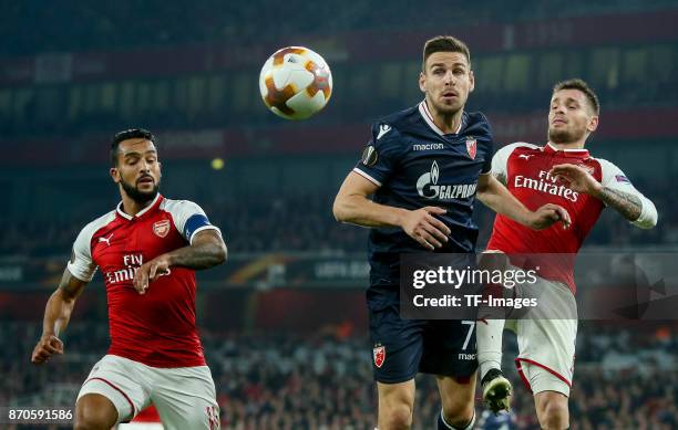 Mathieu Debuchy of Arsenal, Theo Walcott of Arsenal and Nenad Krsticic of Red Star Belgrade battle for the ball during UEFA Europa League Group H...