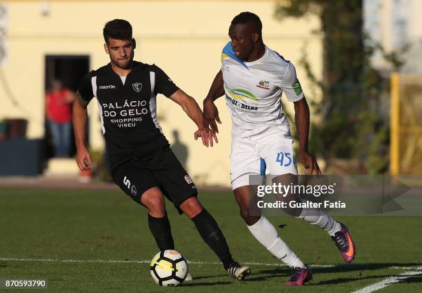 Real SC forward Abdoulaye Diallo from Senegal with AC Viseu defender Kiko in action during the Segunda Liga match between Real SC and AC Viseu at...