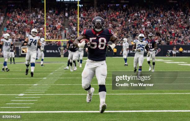 Lamarr Houston of the Houston Texans returns a fumble for a touchdown in the second quarter against the Indianapolis Colts at NRG Stadium on November...