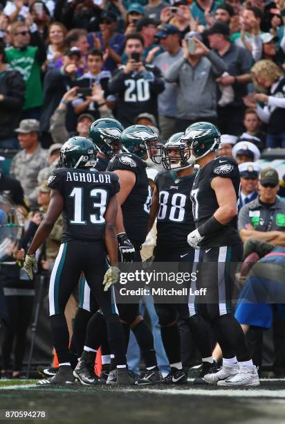 Tight end Trey Burton of the Philadelphia Eagles celebrates his touchdown with teammates against the Denver Broncos during the second quarter at...