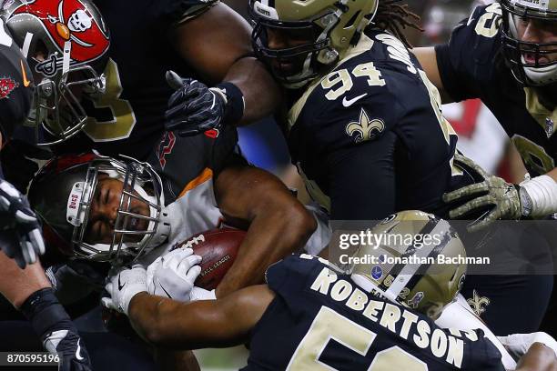 Doug Martin of the Tampa Bay Buccaneers is tackled by the New Orleans Saints defense during the first half of a game at Mercedes-Benz Superdome on...