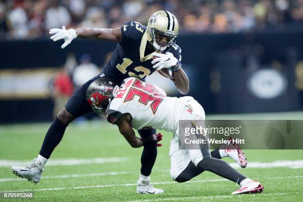 Michael Thomas of the New Orleans Saints is tackled by Robert McClain of the Tampa Bay Buccaneers at Mercedes-Benz Superdome on November 5, 2017 in...