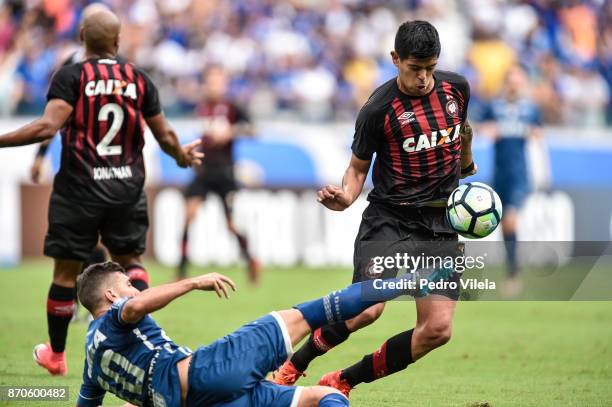 Arrascaeta of Cruzeiro and Esteban Pavez of Atletico PR battle for the ball during a match between Cruzeiro and Atletico PR as part of Brasileirao...