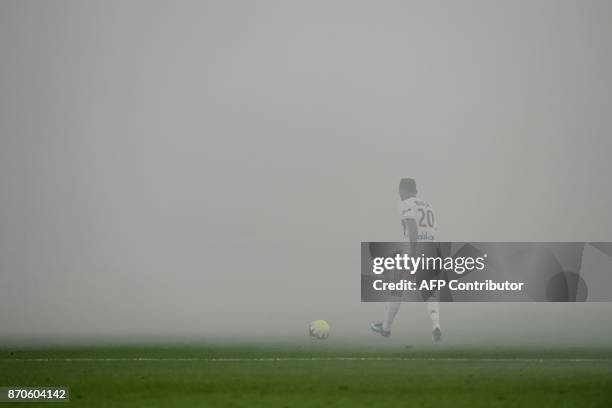 Smokes fills the air interrupting the match after smoke bombs were lobbed during the L1 football match AS Saint-Etienne vs Olympique Lyonnais on...