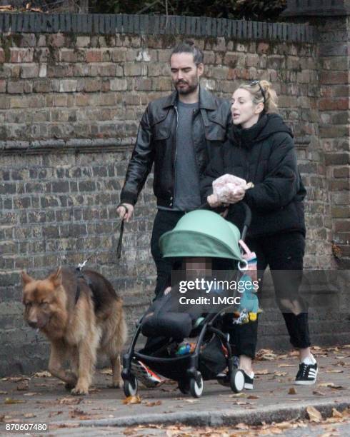Russell Brand and Laura Gallacher talk their bay daughter Mabel for a stroll round Primrose Hill on November 5, 2017 in London, England.
