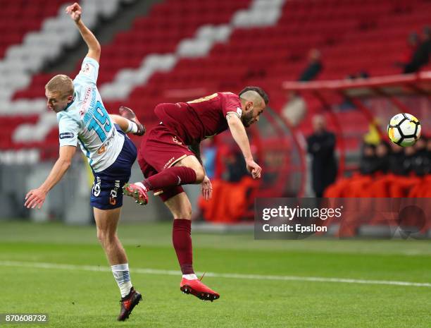 Fyodor Kudryashov of FC Rubin Kazan vies for the ball with Igor Smolnikov FC Zenit Saint Petersburg during the Russian Premier League match between...