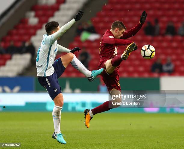 Ruslan Kambolov of FC Rubin Kazan vies for the ball with Matías Kranevitter FC Zenit Saint Petersburg during the Russian Premier League match between...