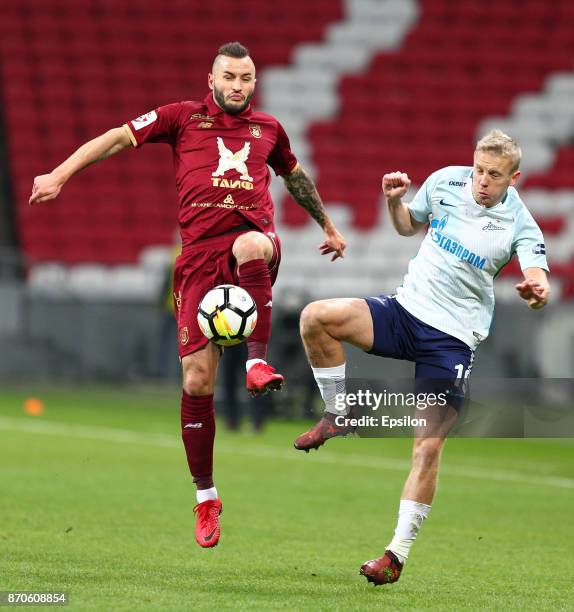 Fyodor Kudryashov of FC Rubin Kazan vies for the ball with Igor Smolnikov FC Zenit Saint Petersburg during the Russian Premier League match between...