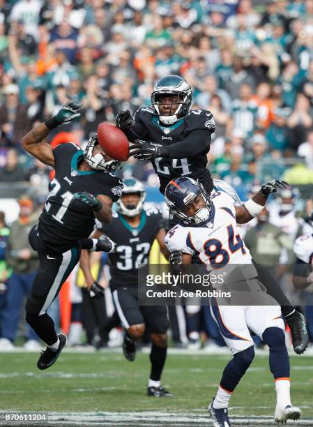 Defensive back Corey Graham and cornerback Patrick Robinson of the Philadelphia Eagles reach for an incomplete pass against the Denver Broncos during...