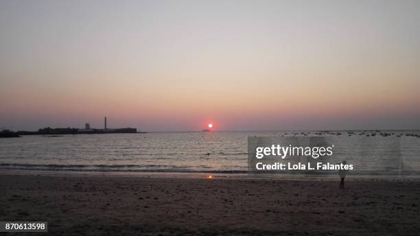 running at sunset in caleta beach,, cadiz - playa de la caleta stock pictures, royalty-free photos & images