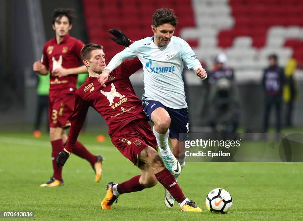 Ruslan Kambolov of FC Rubin Kazan vies for the ball with Yuri Zhirkov FC Zenit Saint Petersburg during the Russian Premier League match between FC...