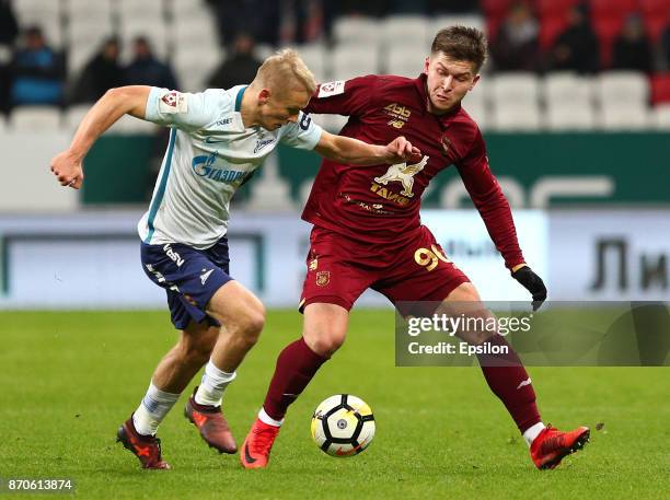 Rifat Zhemaletdinov of FC Rubin Kazan vies for the ball with Igor Smolnikov FC Zenit Saint Petersburg during the Russian Premier League match between...