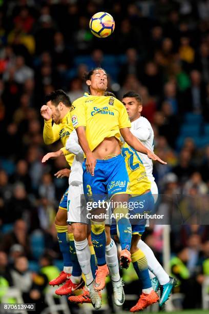 Las Palmas' Uruguayan defender Mauricio Lemos heads the ball with Real Madrid's Brazilian midfielder Casemiro during the Spanish league football...