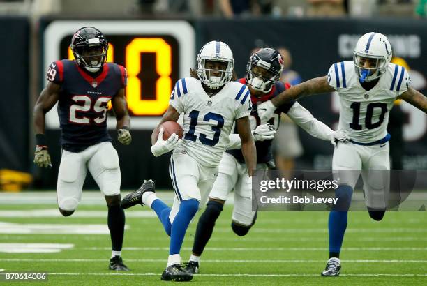 Hilton of the Indianapolis Colts runs the ball after a reception defended by Andre Hal of the Houston Texans during the third quarter at NRG Stadium...
