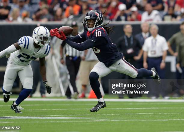 DeAndre Hopkins of the Houston Texans misses a pass defended by Nate Hairston of the Indianapolis Colts in the third quarter at NRG Stadium on...