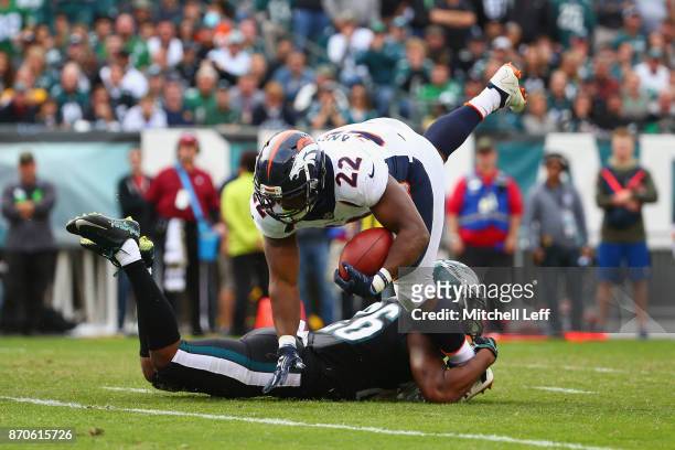 Cornerback Jaylen Watkins of the Philadelphia Eagles tackles running back C.J. Anderson of the Denver Broncos during the second quarter at Lincoln...