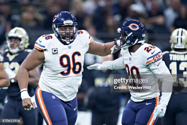 Akiem Hicks and Prince Amukamara of the Chicago Bears celebrate after a big tackle during a game against the New Orleans Saints at Mercedes-Benz...