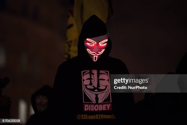 Protester wears the iconic Guy Fawkes mask in Trafalgar Square during the anti-capitalist 'Million Masks March', organised by the group Anonymous, to...