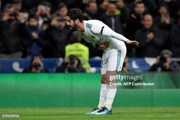 Real Madrid's Spanish midfielder Isco bows as he celebrates after scoring a goal during the Spanish league football match Real Madrid CF vs UD Las...