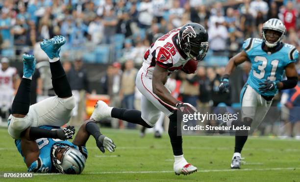 Tevin Coleman of the Atlanta Falcons runs the ball against the Carolina Panthers in the fourth quarter during their game at Bank of America Stadium...