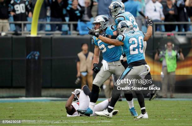 Luke Kuechly and teammate Kurt Coleman of the Carolina Panthers celebrate a pass breakup against the Atlanta Falcons in the fourth quarter during...