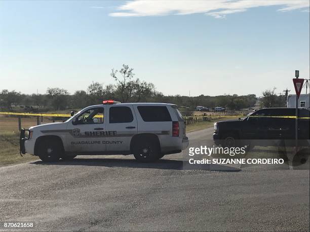 Police block a road in Sutherland Springs, Texas on November 5 after a mass shooting a church nearby. - A gunman shot dead at least 20 worshippers...