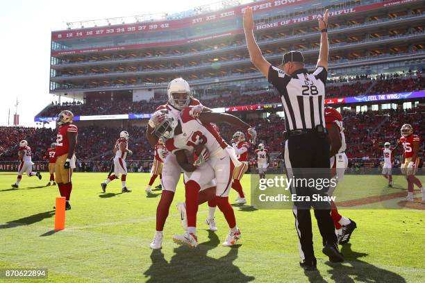 Jaron Brown of the Arizona Cardinals celebrates with Larry Fitzgerald after a touchdown against the San Francisco 49ers during their NFL game at...