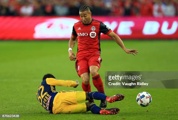 Justin Morrow of Toronto FC is tackled by Michael Amir Murillo of New York Red Bulls during the first half of the MLS Eastern Conference Semifinal,...
