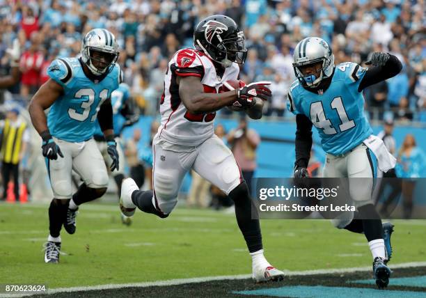 Tevin Coleman of the Atlanta Falcons runs for a touchdown against the Carolina Panthers in the fourth quarter during their game at Bank of America...